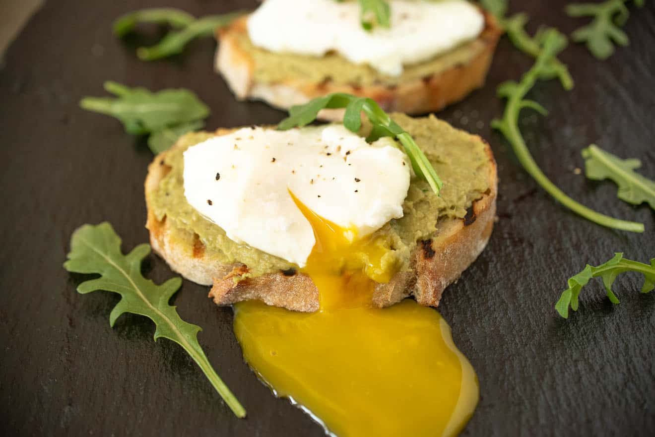 Avocado-artichoke toast with poached egg